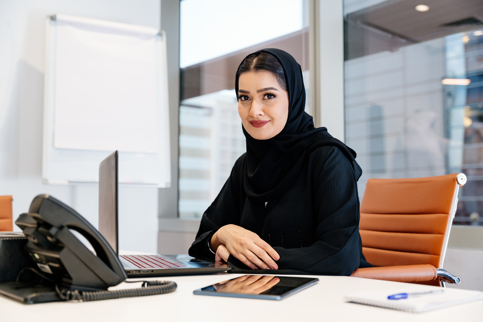 Middle-eastern businesswoman wearing traditional arab abaya work